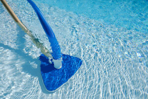Cleaning A Swimming Pool Using A Pool Hoover